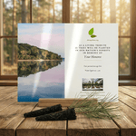 Memorial card with nature-themed design on a wooden surface