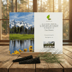 Memorial card with mountain and nature scene on a wooden surface