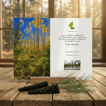 Memorial card for planting trees in memory of a deceased person on a wooden surface with a forest background.