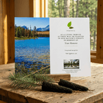 Memorial card with nature-themed design on a wooden surface