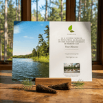 Memorial card for tree planting in honor of a deceased person with a scenic lake and forest background.