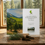 Memorial tree planting card with scenic Arizona mountain view on a wooden surface