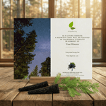 Memorial card for planting a redwood tree with nature-themed design on a wooden surface.