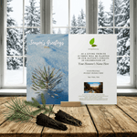 Holiday card with tree planting message on a wooden surface with a snowy window background