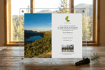 Acrylic plaque with nature-themed design and text on a wooden surface with a window view.